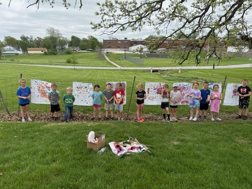 Kindergarten students exploring nature outside today painting
