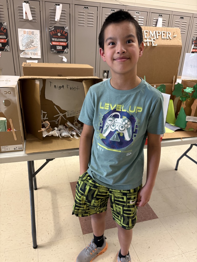 Student shows off his display at PACE open house