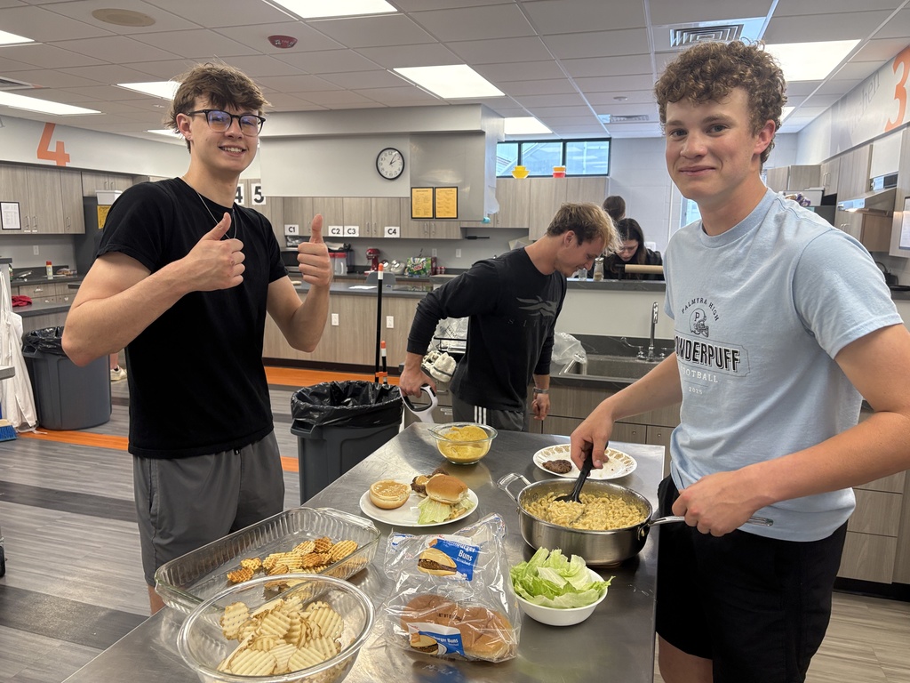 3 students with their burger and fries in Foods class