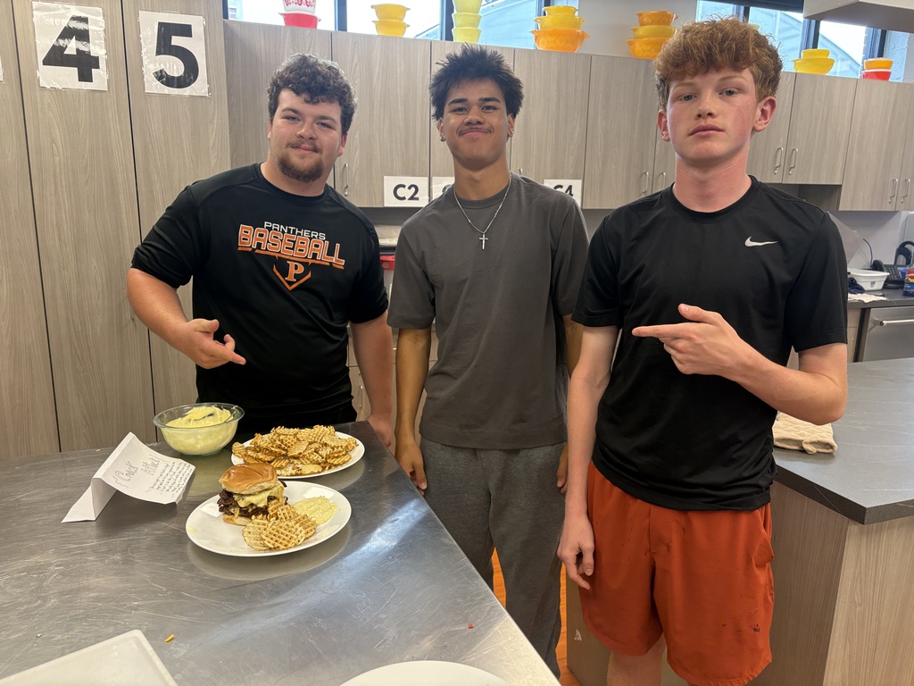 3 students with their burger and fries in Foods class