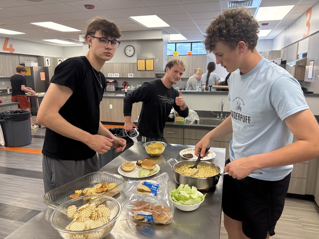 3 students with their burger and fries in Foods class