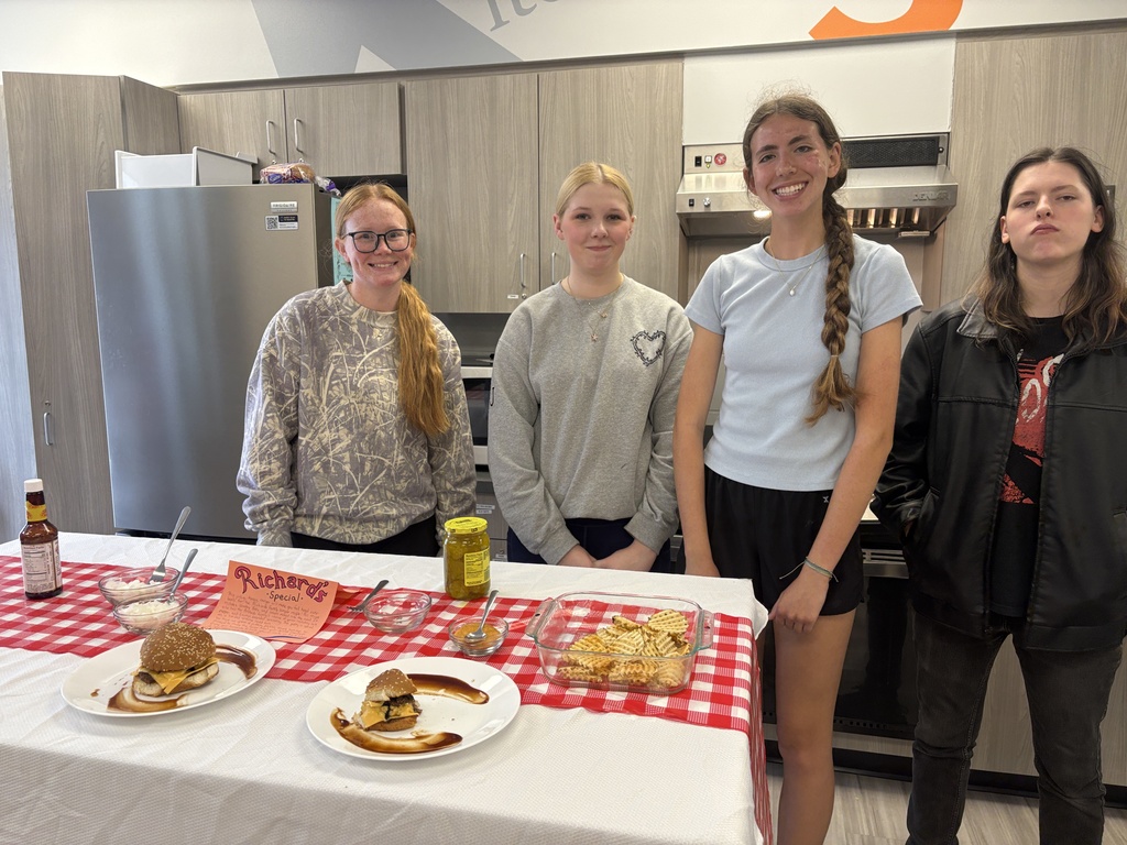 4 students with their burger and fries in Foods class