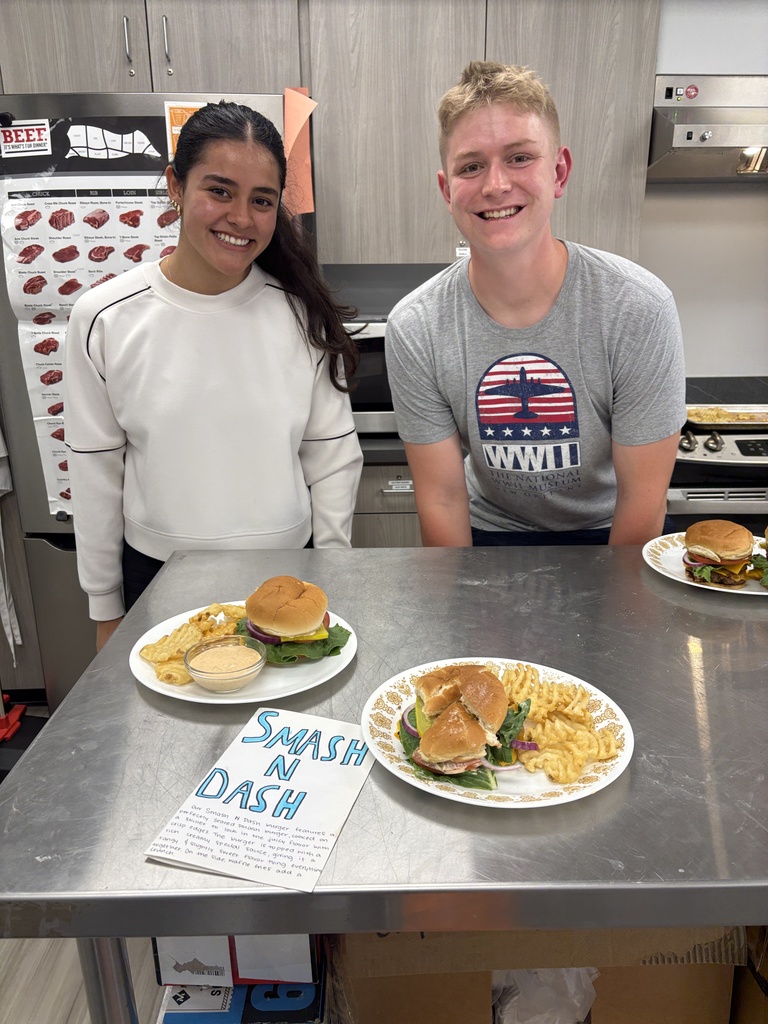 2 students with their Smash and Dash burger and fries in Foods class