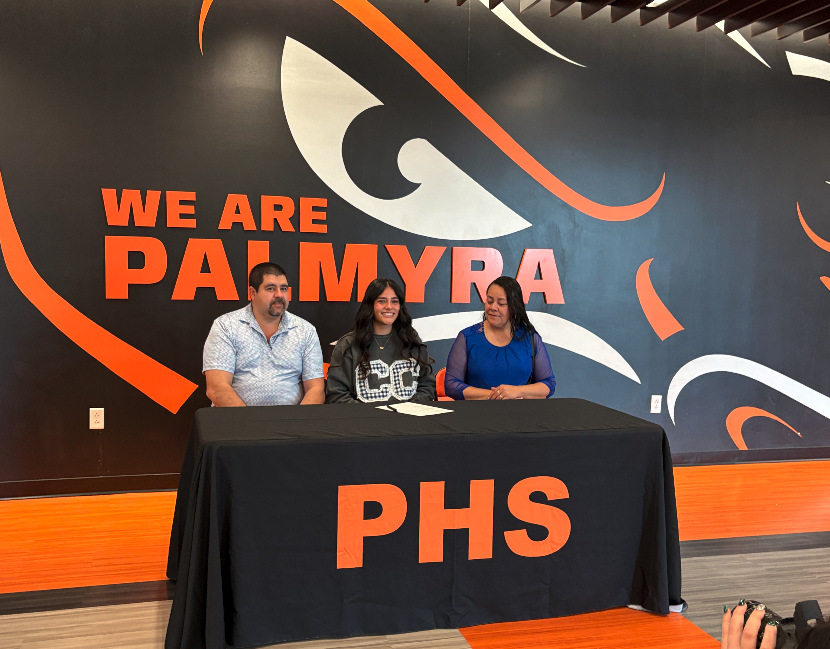 student with their families signing their NLI