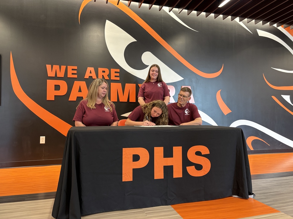 student with their families signing their NLI