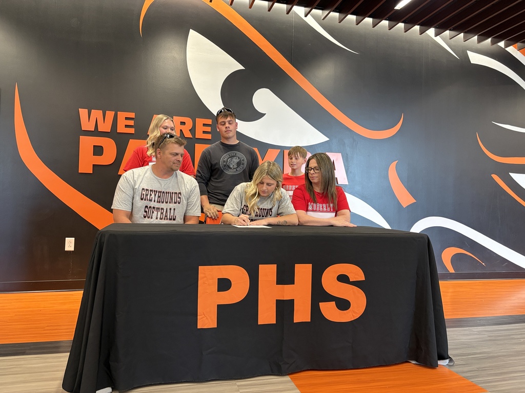 student with their families signing their NLI