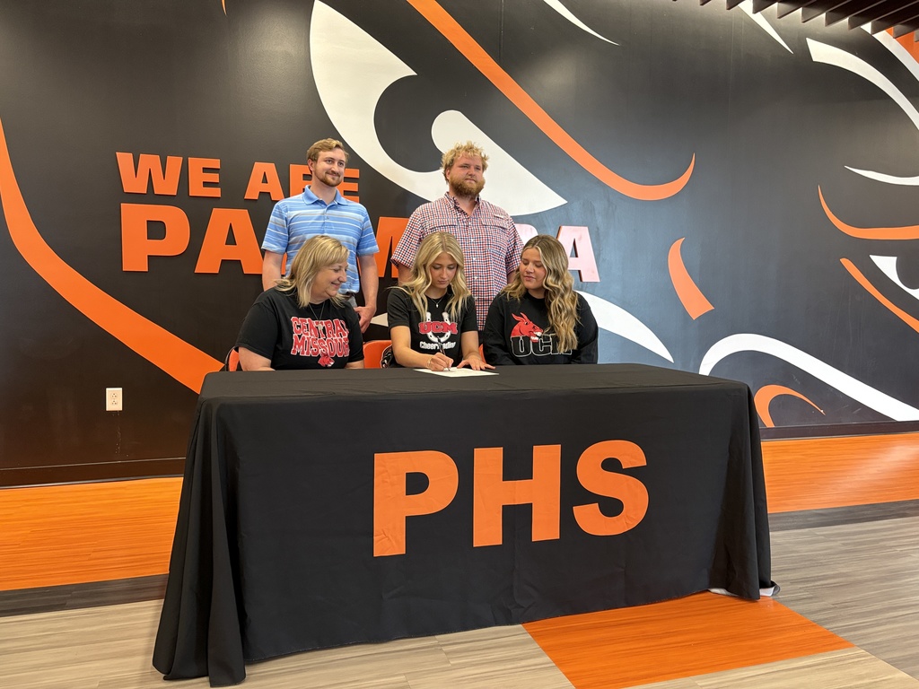 student with their families signing their NLI