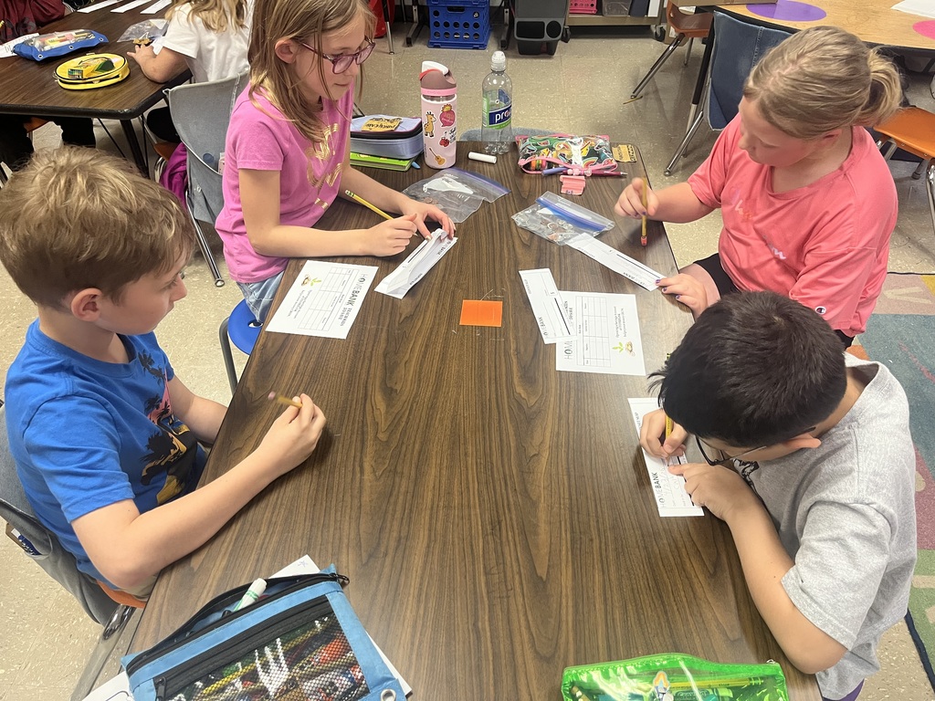 2nd grade students counting money and working with HOMEBANK to learning banking skills