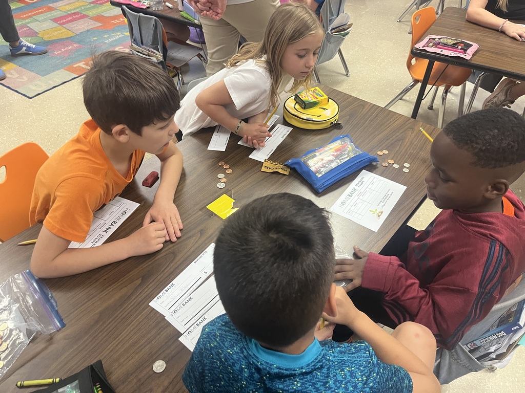 2nd grade students counting money and working with HOMEBANK to learning banking skills