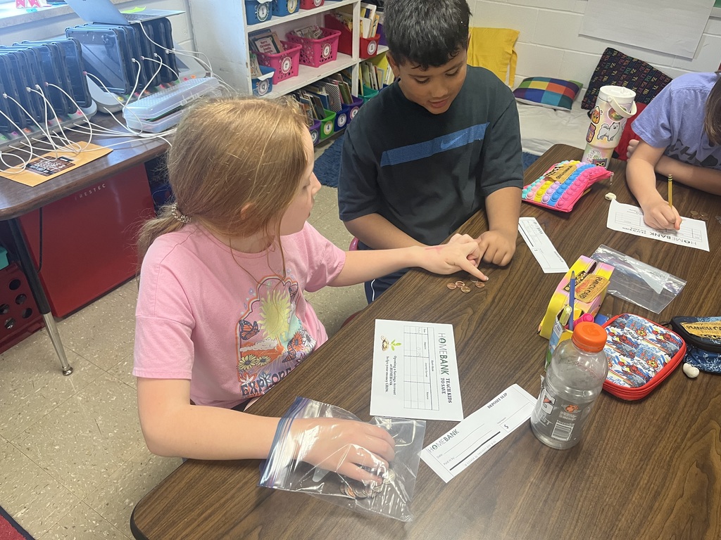 2nd grade students counting money and working with HOMEBANK to learning banking skills