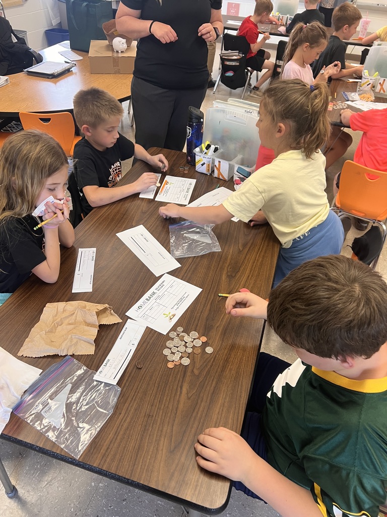 2nd grade students counting money and working with HOMEBANK to learning banking skills
