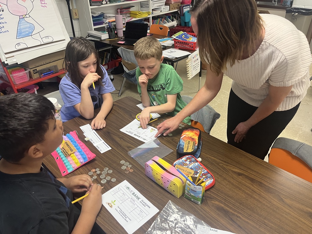 2nd grade students counting money and working with HOMEBANK to learning banking skills