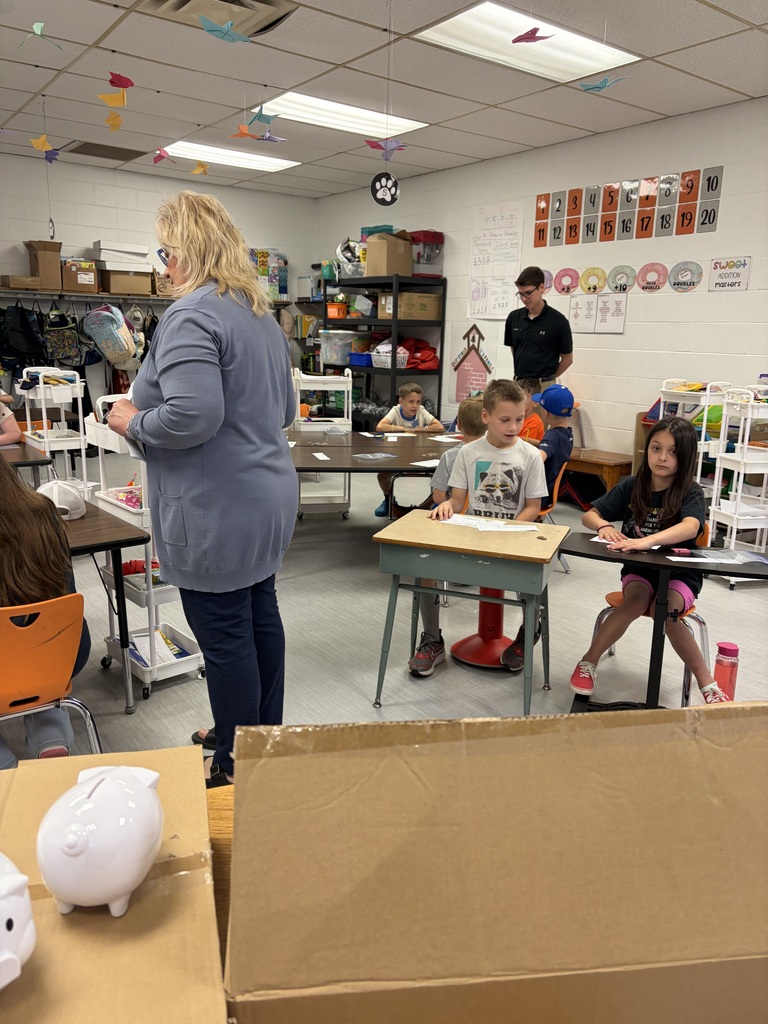 2nd grade students counting money and working with HOMEBANK to learning banking skills