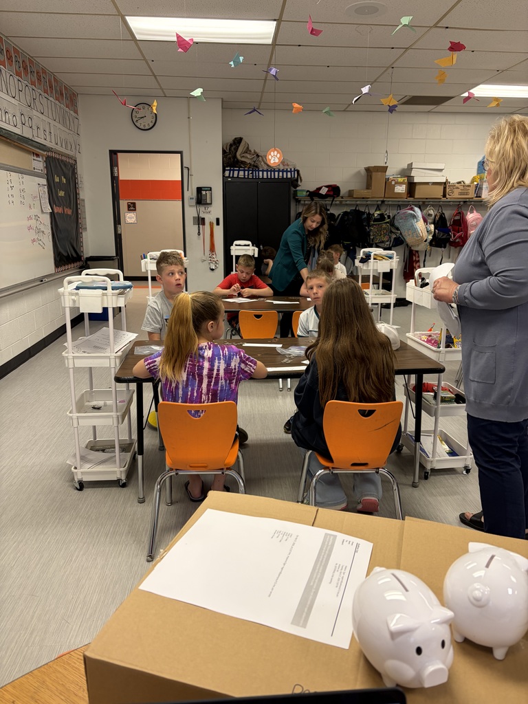 2nd grade students counting money and working with HOMEBANK to learning banking skills