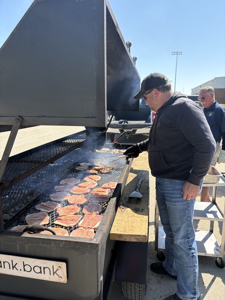 Kiwanis members grilling pork chops