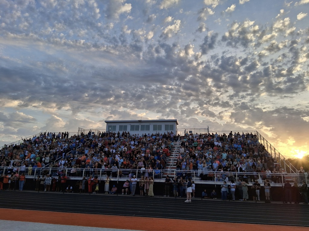 Bleachers full of families and friends during graduation ceremony