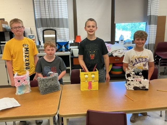 summer school students with the shoebox puppets they created