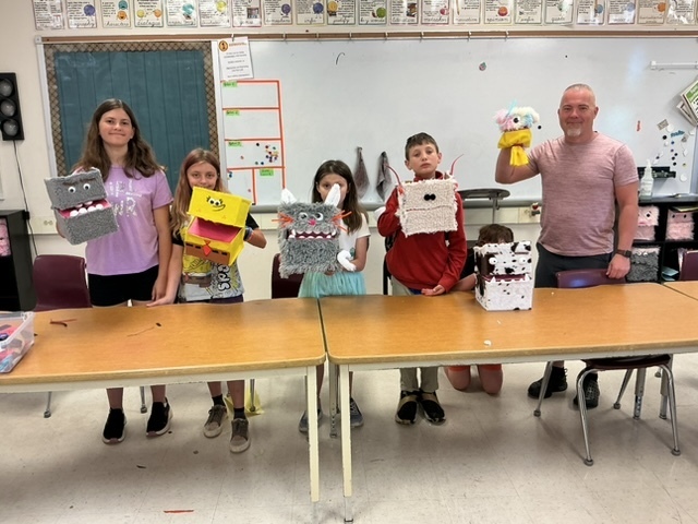 summer school students with the shoebox puppets they created