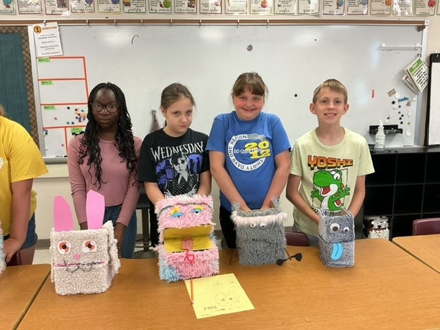 summer school students with the shoebox puppets they created