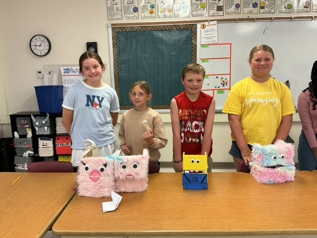 summer school students with the shoebox puppets they created