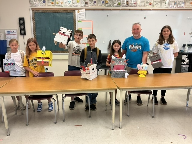 summer school students with the shoebox puppets they created