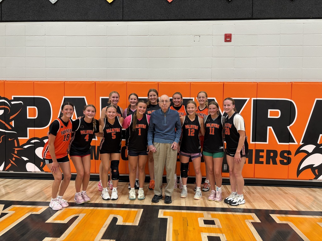 Mr Lenzini viewing the gym renovations posing with basketball team