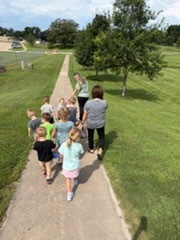child care students taking a walk with teachers
