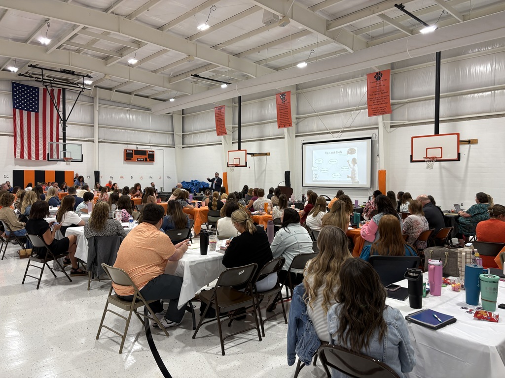 Staff listening to speaker, Josh Varner in PES Gym