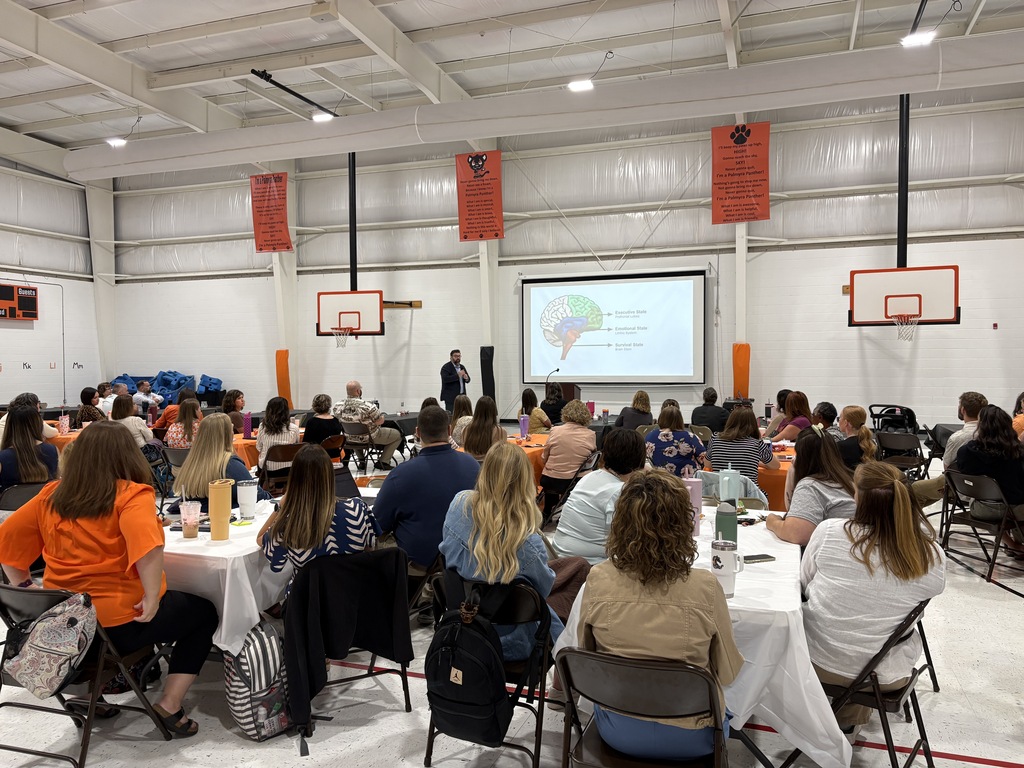 Staff listening to speaker, Josh Varner in PES Gym