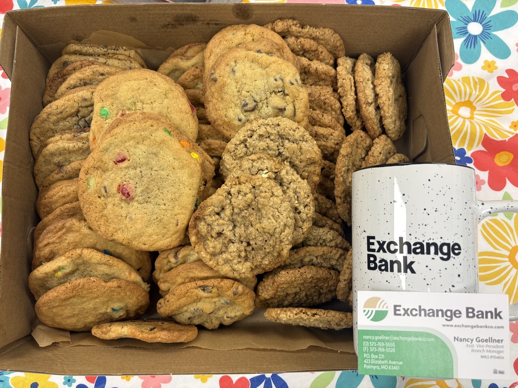 Exchange Bank Nancy with cup and cookies for staff