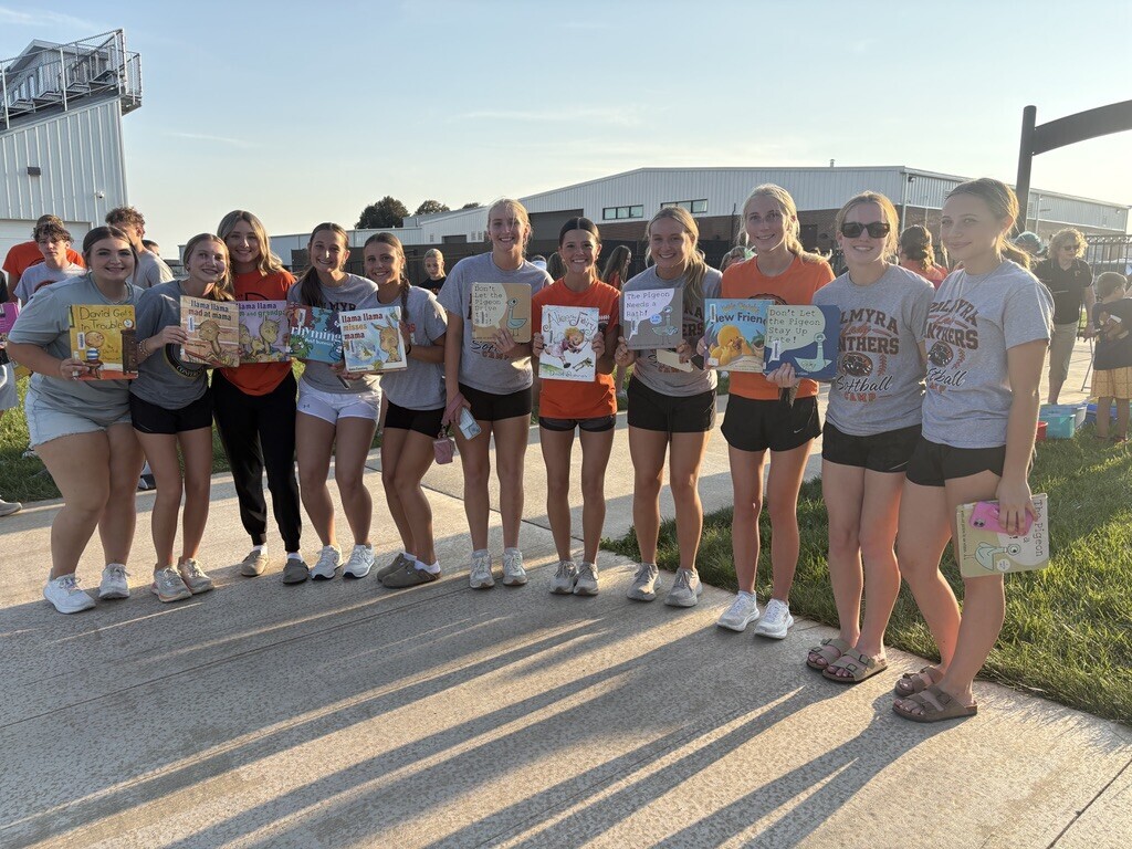 PHS students with books at Pages with Panthers event