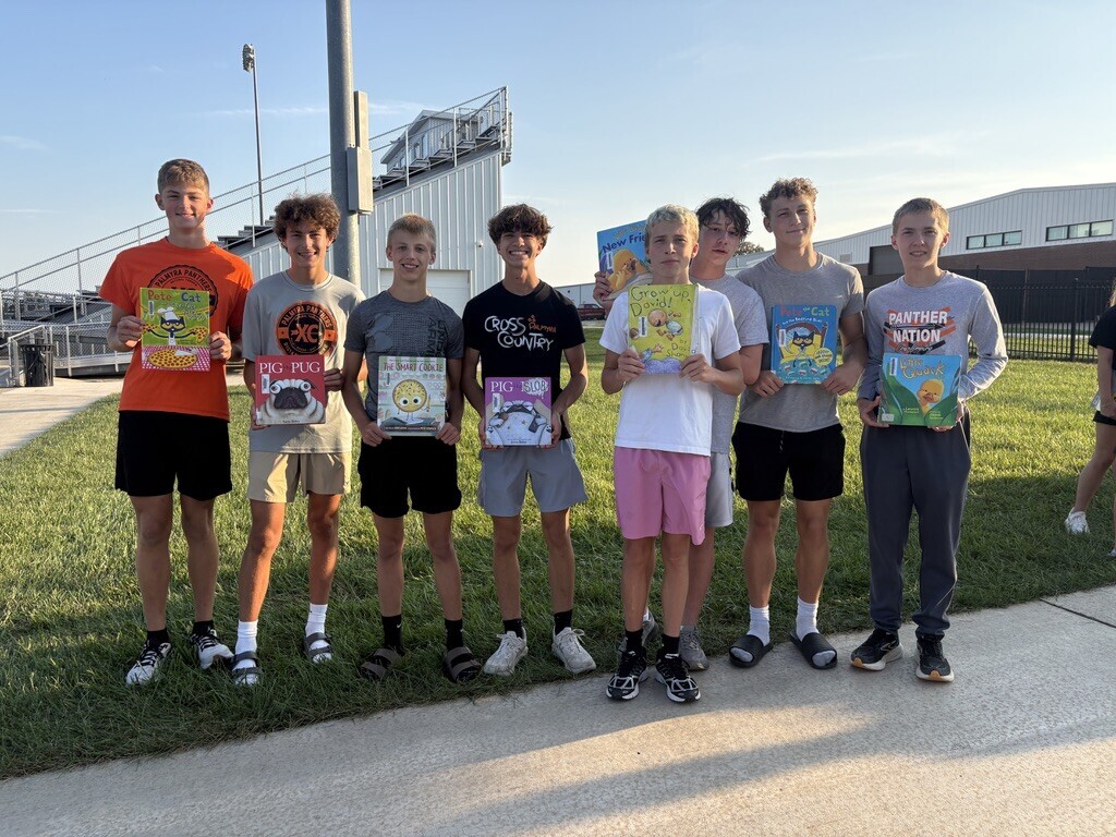 PHS students with books at Pages with Panthers event