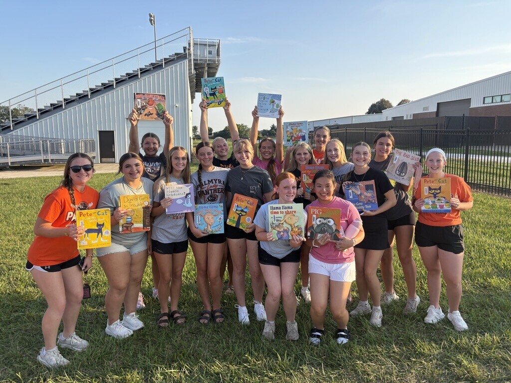 PHS students with books at Pages with Panthers event