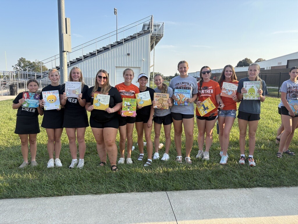 PHS students with books at Pages with Panthers event