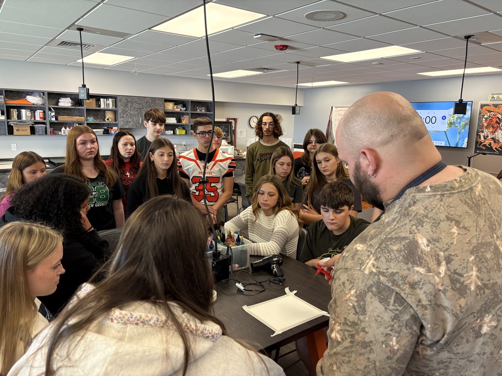 Mr. Walker demonstrating art technique with students