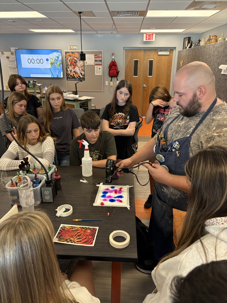 Mr. Walker demonstrating art technique with students