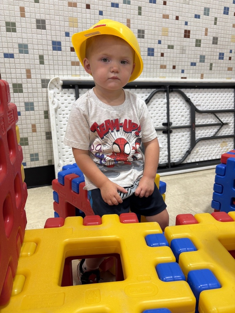 PAT playgroup participant holder plastic tools and wearing hardhat