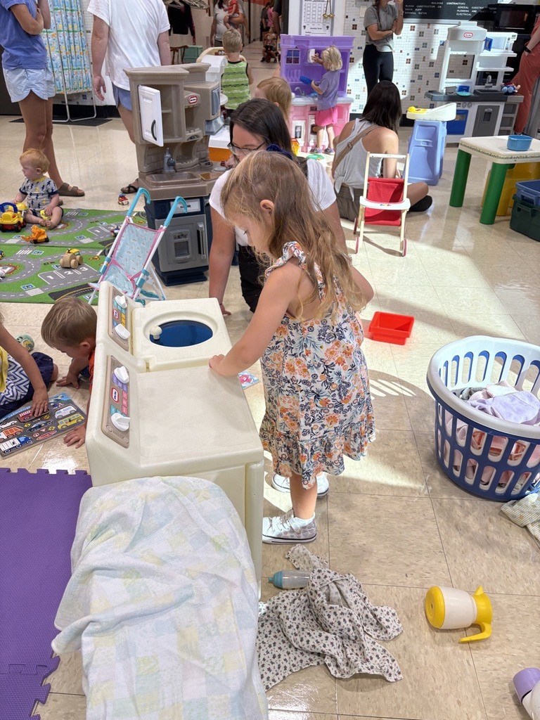 PAT playgroup participant playing with toy washer and dryer