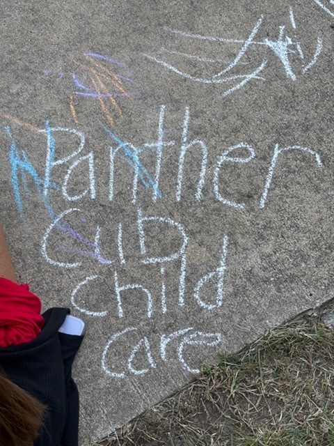 Panther Cub Child Care written in chalk on sidewalk