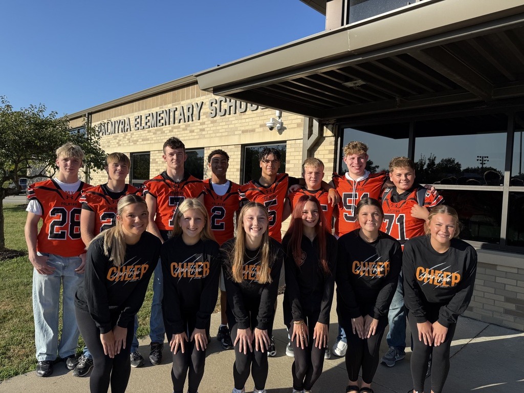 Panther Football and Cheer in group picture in front of Palmyra Elementary School