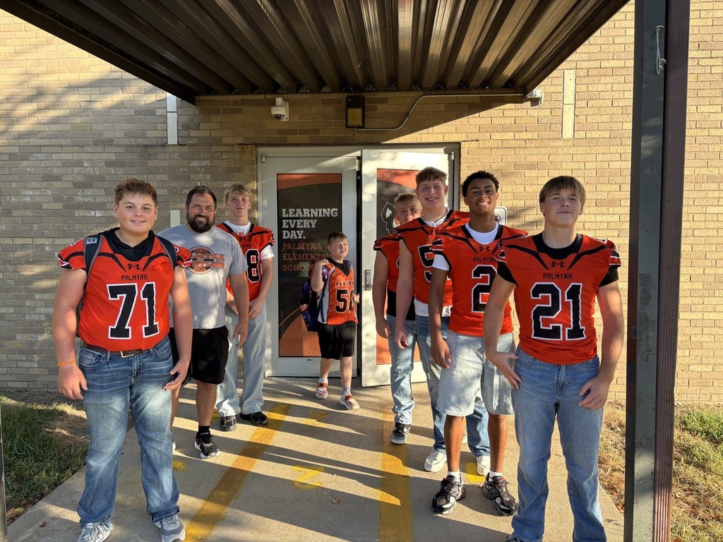 Panther Football in front of Palmyra Elementary School greeting students
