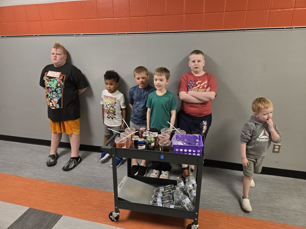 students delivering drinks in a hallway