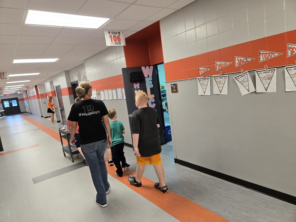 students and staff member delivering drinks in a hallway