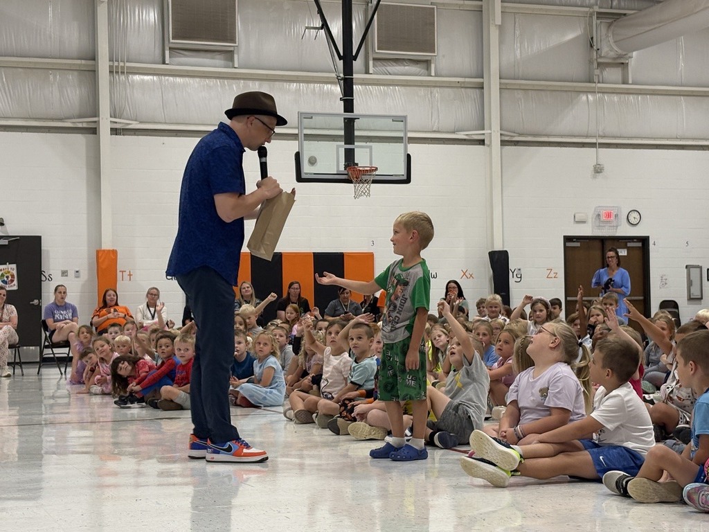 Man talking with student during assembly