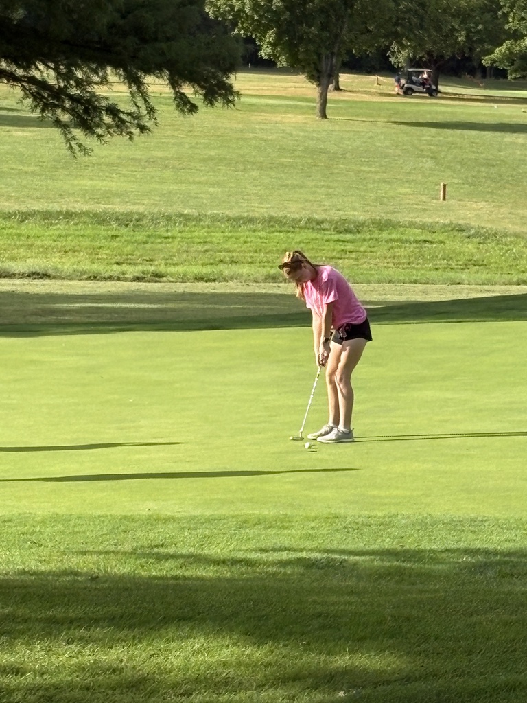 lady golfer putting on green