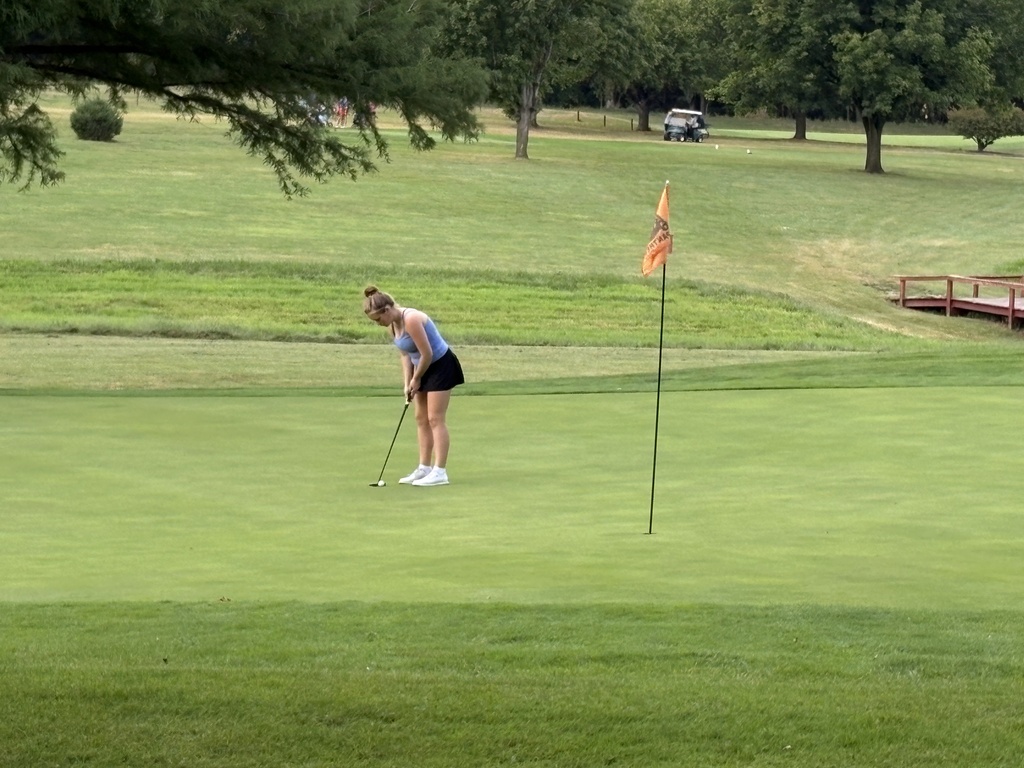 lady golfer putting on green