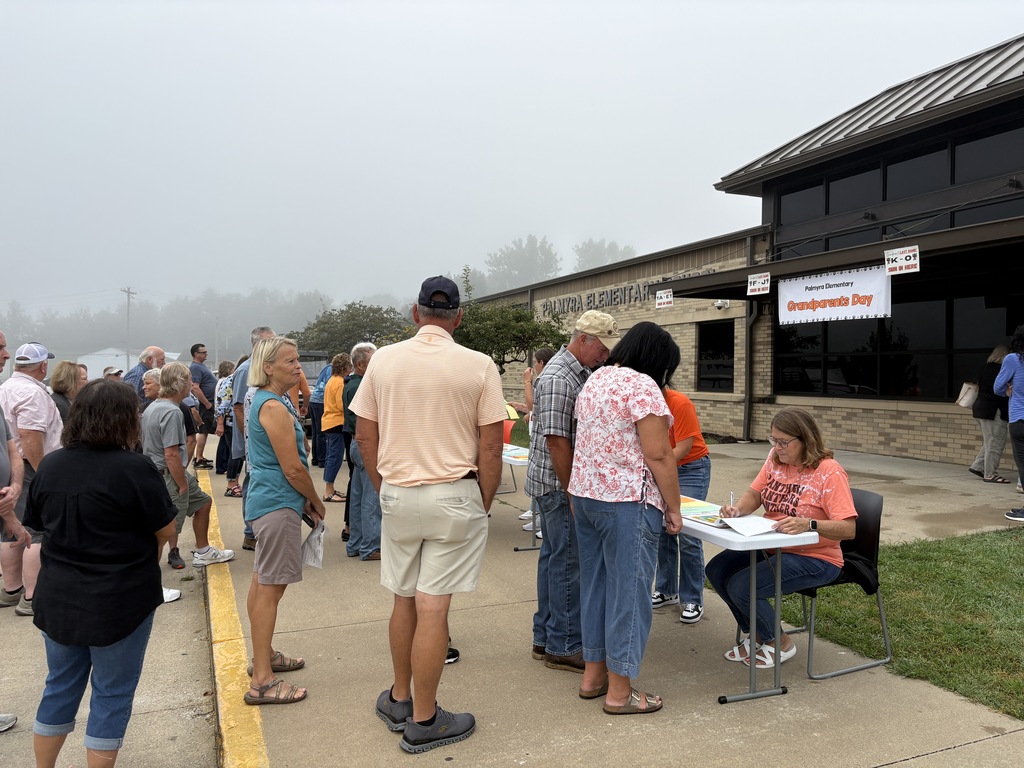 Grandparents lined up at registration tables