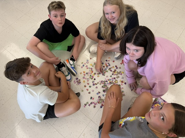 students working on puzzle in classroom