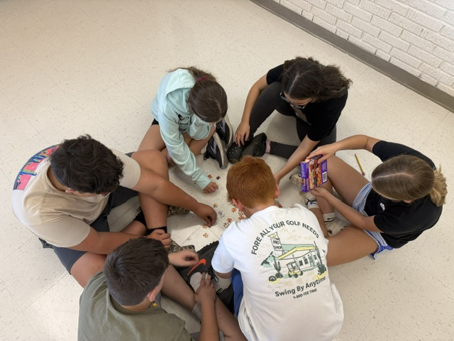 students working on puzzle in classroom