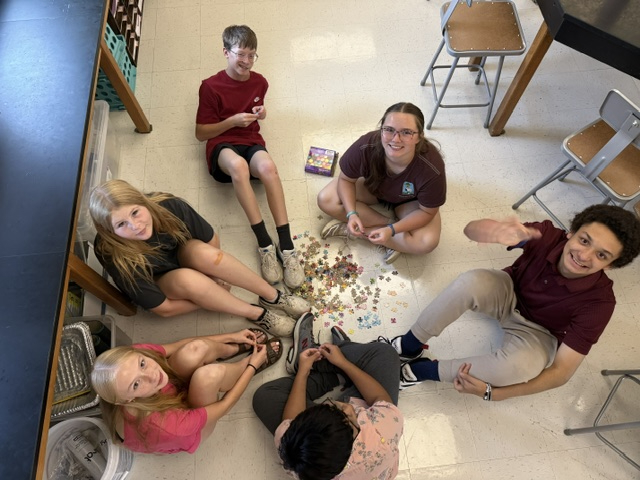 students working on puzzle in classroom